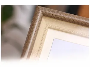 Macro shot of 90-degree corner joint and beaded decoration on wooden texture frame