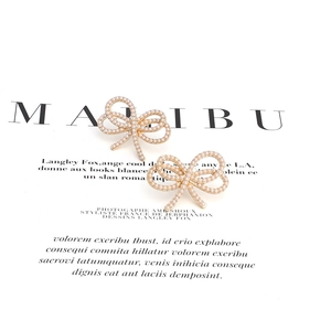 Elegant bow stud earrings with white pearls and gold alloy base for women