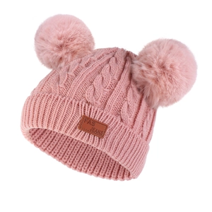 Pink winter cable knit baby hat with double fur pom-poms and warm ear protection