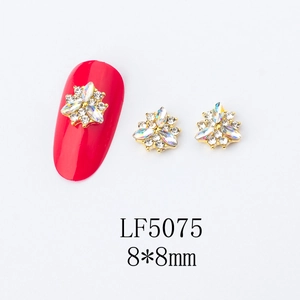 Detail of 8x8mm gold flower nail art charms with iridescent rhinestones and crystals