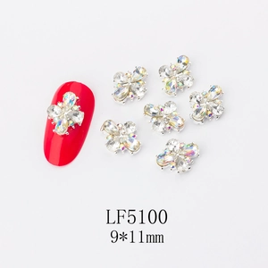 Macro detail of LF5100 9x11mm 3D AB crystal flower nail art charm on red manicure