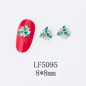 Green and white crystal flower nail art charms 8x8mm size shown on a red nail