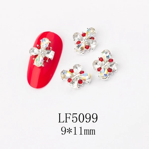 Macro detail of 9x11mm 3D butterfly nail art charm with silver alloy and red rhinestones
