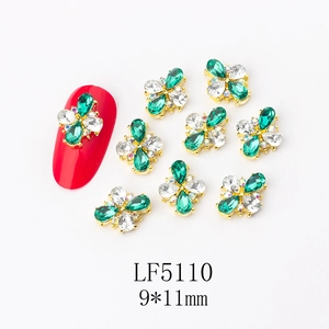 Detail of 9x11mm green crystal butterfly nail charms with gold metallic base