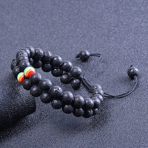 Macro detail of hand-woven volcanic stone bracelet with colorful beads and adjustable cord