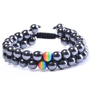 Detail of double-layer beaded bracelet with rainbow stones and adjustable black woven cord