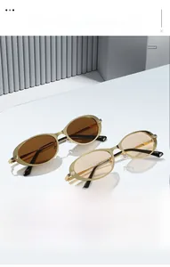 Detailed view of luxury oval gold frames with fine horizontal texture on the temples
