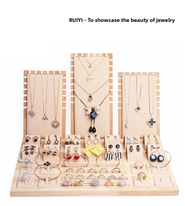 Detailed set of wooden jewelry display stands with beige microfiber necklace and earring holders