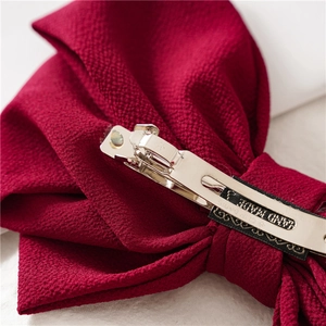 Deep red fabric triple-layered bow hair clip with silver metal spring clip fastener