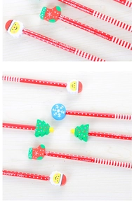 Christmas HB pencils with Santa and Christmas tree shaped erasers on wooden background