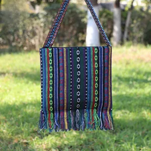 Ethnic style woven crossbody bag featuring colorful stripes and fringe detail accents