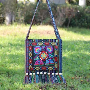 Detailed close-up of colorful floral embroidery and fringe on ethnic crossbody bag