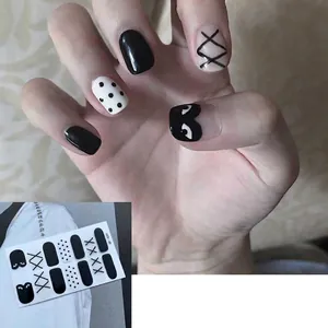 Black and white polka dot 3D nail art stickers with minimalist eye and cross patterns