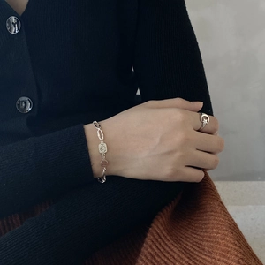 Close-up of 925 sterling silver boy charm bracelet and moon star ring on model