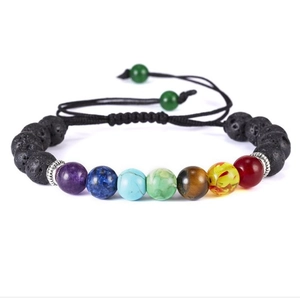 Detailed macro view of 7-color chakra beads on adjustable lava stone woven bracelet