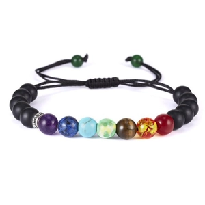 Detailed macro shot of adjustable braided rainbow beaded bracelet with colorful beads
