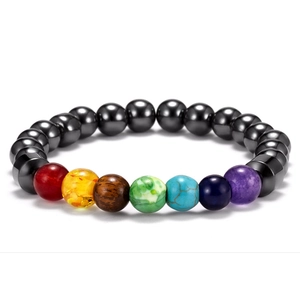 Detail view of colorful seven chakra natural stone beads on a dark metallic bracelet