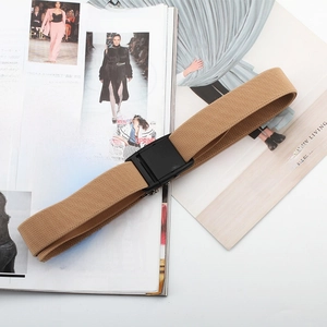 Detail of khaki elastic woven belt with black buckle on a fashion magazine background