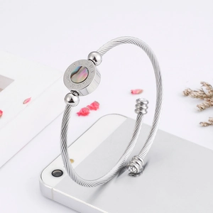 Silver stainless steel cable bangle featuring Roman numerals and iridescent shell inlay
