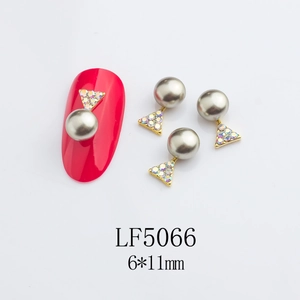 Detail of 6x11mm star-shaped alloy nail art charms with grey pearl and rhinestones