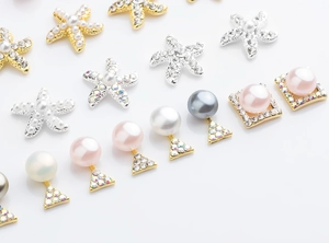 Detail of starfish and geometric alloy nail art charms with pearls and rhinestones