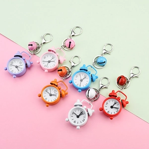 Detailed view of colorful mini alarm clock keychains in various vibrant pastel shades.