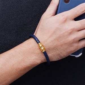 Men's navy blue braided leather bracelet with a gold metal clasp shown on wrist