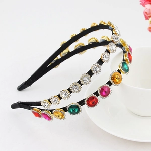 Close-up of sparkling colorful rhinestones and crystal flower detailing on a black headband