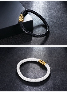 Close-up of black and white braided leather bracelets with gold magnetic clasps