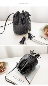 Détail du sac seau noir avec texture gaufrée circulaire et cordons à glands