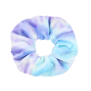Detailed texture of blue and purple tie-dye velvet hair scrunchie on white background