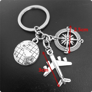 Detailed dimensions of silver globe, compass, and airplane pendants on a keychain