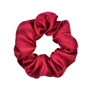 Detailed view of the smooth red satin texture on this elastic hair scrunchie