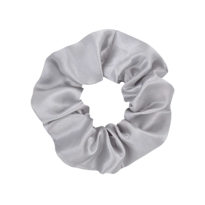 Close-up of silver-grey satin silk scrunchie with smooth metallic luster and soft texture