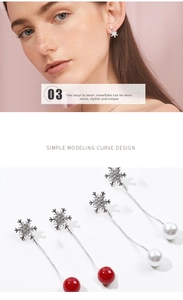 Close-up of snowflake dangle earrings with detachable pearls and rhinestones