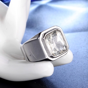 Macro view of a chunky men's stainless steel ring featuring a large rectangular gemstone
