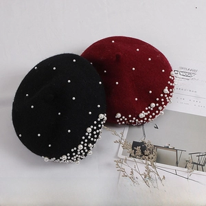 Detailed view of pearl and rhinestone embellishments on wool berets for girls