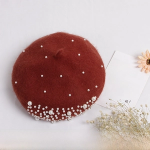 Detailed shot of dark red wool felt beret featuring scattered pearls and rhinestone accents