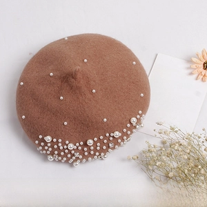 Detail of camel wool beret for girls featuring elegant pearl and rhinestone accents