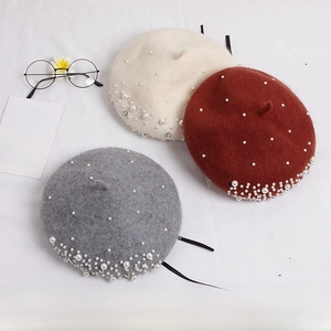 Detailed flat lay of wool berets with pearls and rhinestones for little girls