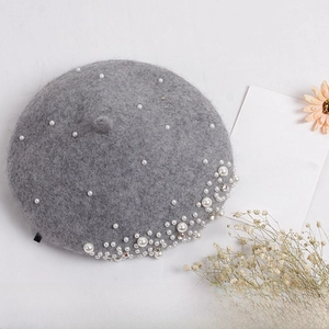 Detailed top view of grey wool beret for girls featuring elegant white pearl accents