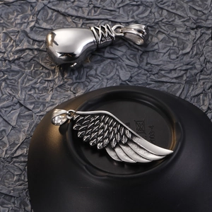 Silver Viking pendants featuring a boxing glove and wing design on a dark textured background