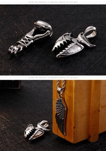 Detail view of silver Viking-inspired pendants featuring boxing glove, shark tooth, and feather