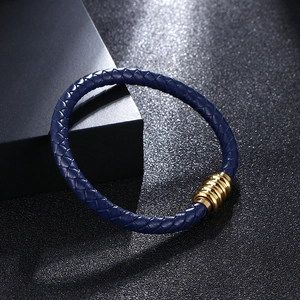 Handwoven dark blue leather bracelet with a polished gold magnetic clasp by gift box
