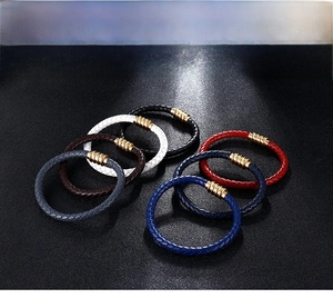 Detailed view of colorful braided leather bracelets with gold magnetic clasps in various shades