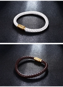 Close-up of woven leather bracelets in white and dark brown with gold magnetic clasps