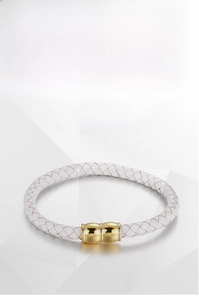 Detail of white braided leather bracelet with golden titanium steel magnetic clasp