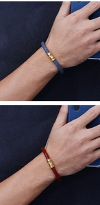Detail of blue and red braided leather bracelets for men with gold magnetic metal clasp