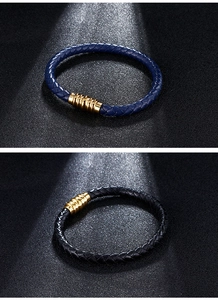 Detail of blue and black woven leather bracelets with golden magnetic metal clasps
