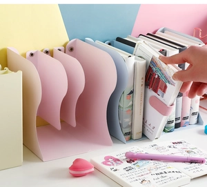 Adjustable metal bookends in pink and pastel blue for desktop organization